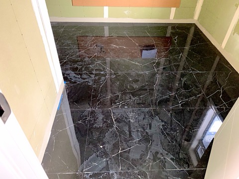 Polished marble-look indoor floor tiling